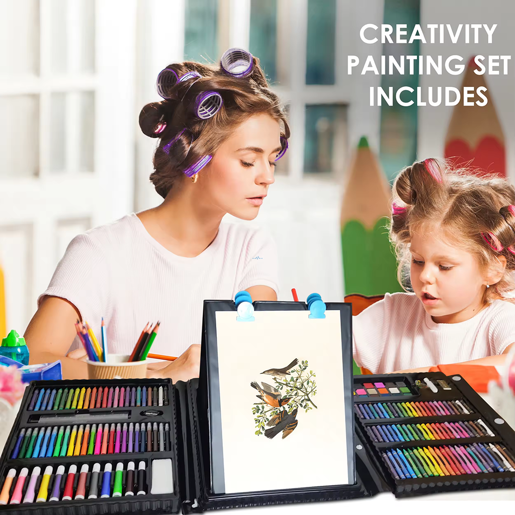Art kit with oil pastels, watercolor cakes and stickers laid out on wooden table
